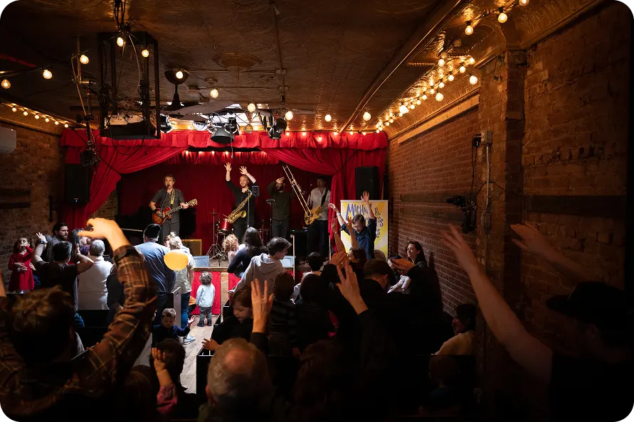 A packed room dancing at a Michael & the Rockness Monsters concert