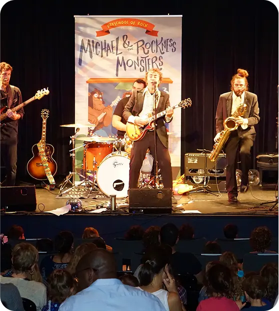 The full band on stage with guitar, trombone, saxophone and drums